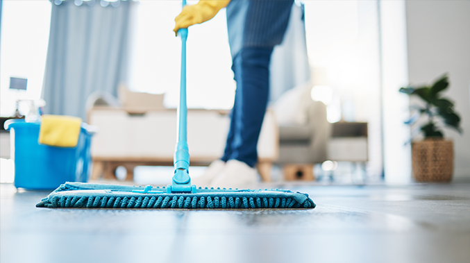 mobile image person in gloves cleaning with mop living room floors